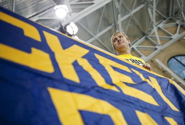Michigan senior Kenrick Aylesworth hangs the band sign at Yost Ice arena on Tuesday. Daniel Brenner I AnnArbor.com